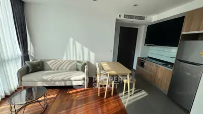 Modern living room with sleek kitchen and stylish furniture in a bright apartment.