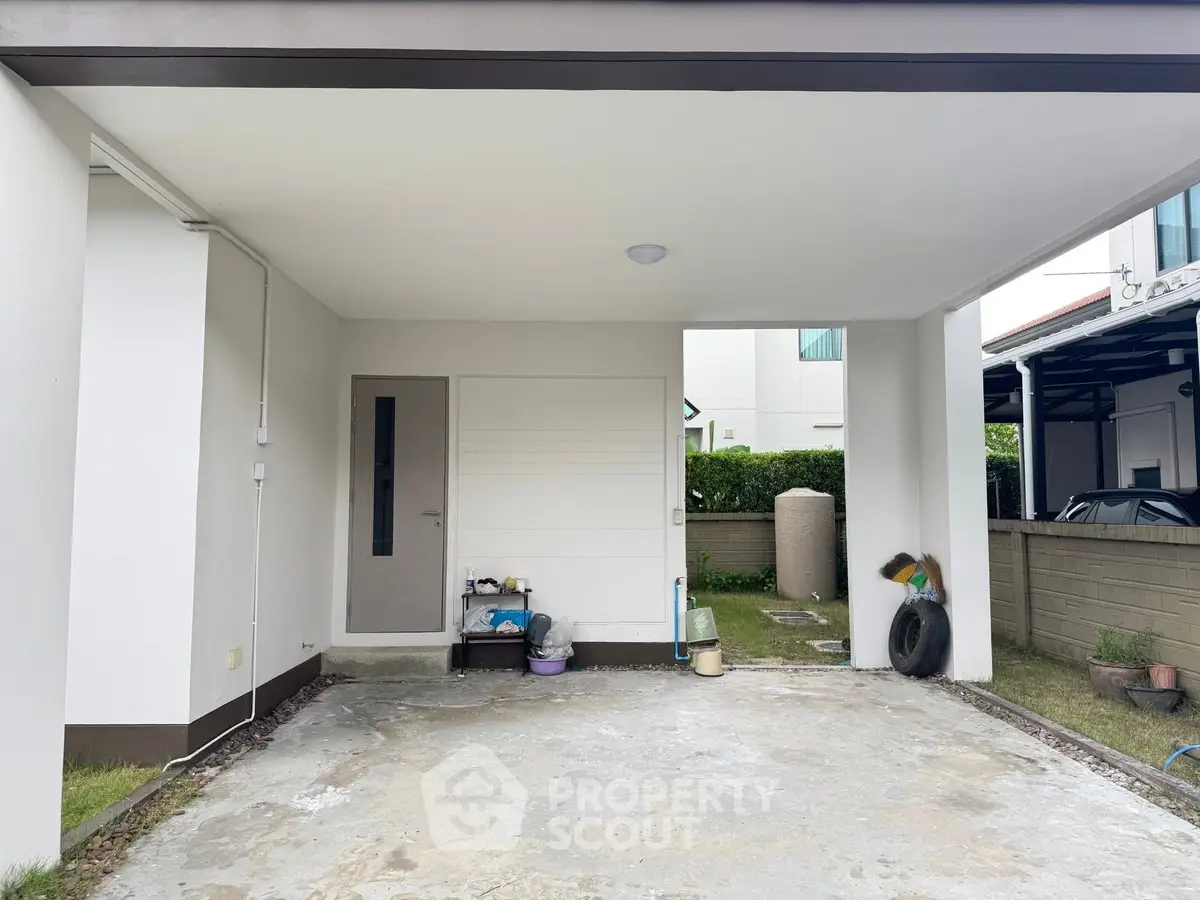 Spacious covered parking area in modern residential property with clean design.
