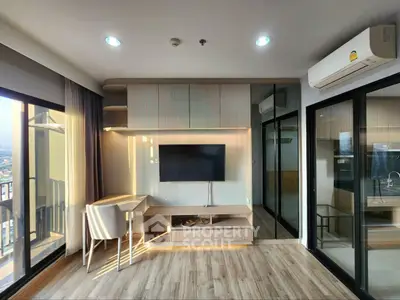 Modern living room with large windows and stylish furniture in a high-rise apartment.