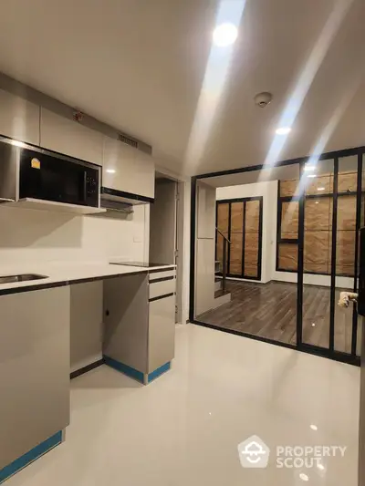 Modern kitchen with sleek cabinetry and open layout in contemporary apartment