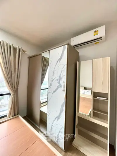 Modern bedroom with stylish wardrobe and air conditioning unit