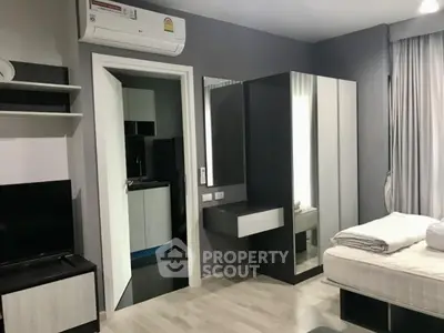 Modern bedroom with sleek furniture and air conditioning in a stylish apartment.