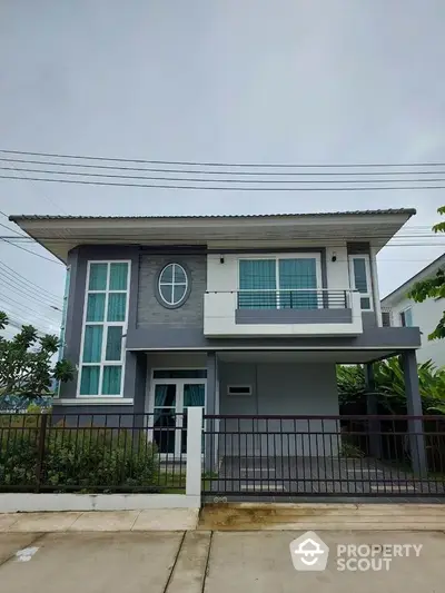 Modern two-story house with balcony and contemporary design