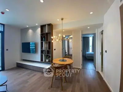 Modern living room with stylish decor and open layout leading to a cozy bedroom.