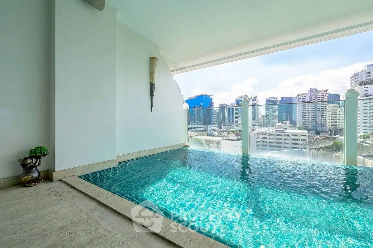 Luxurious rooftop pool with stunning city skyline view in modern high-rise building.