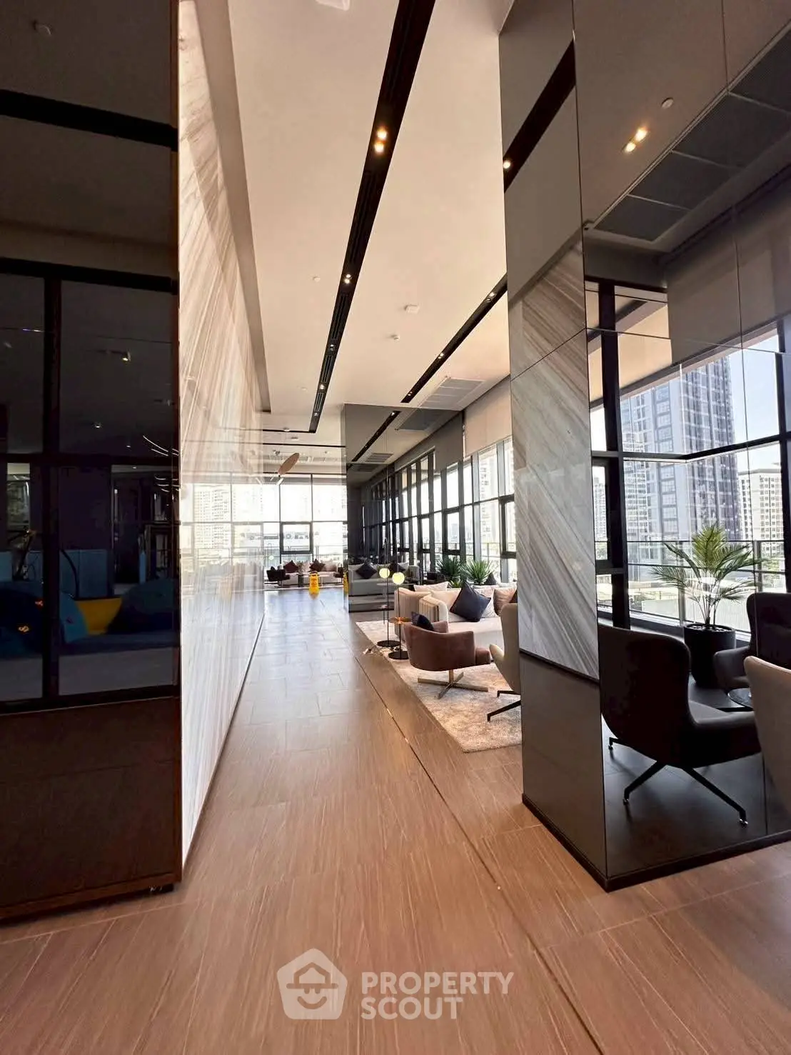Luxurious modern living room with floor-to-ceiling windows and elegant decor in high-rise building.