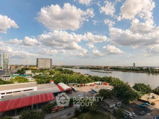 Stunning river view from high-rise building with lush greenery and cityscape.
