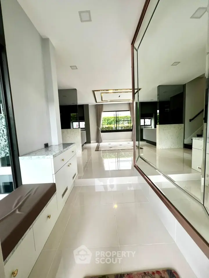 Spacious modern living room with large mirror and elegant decor