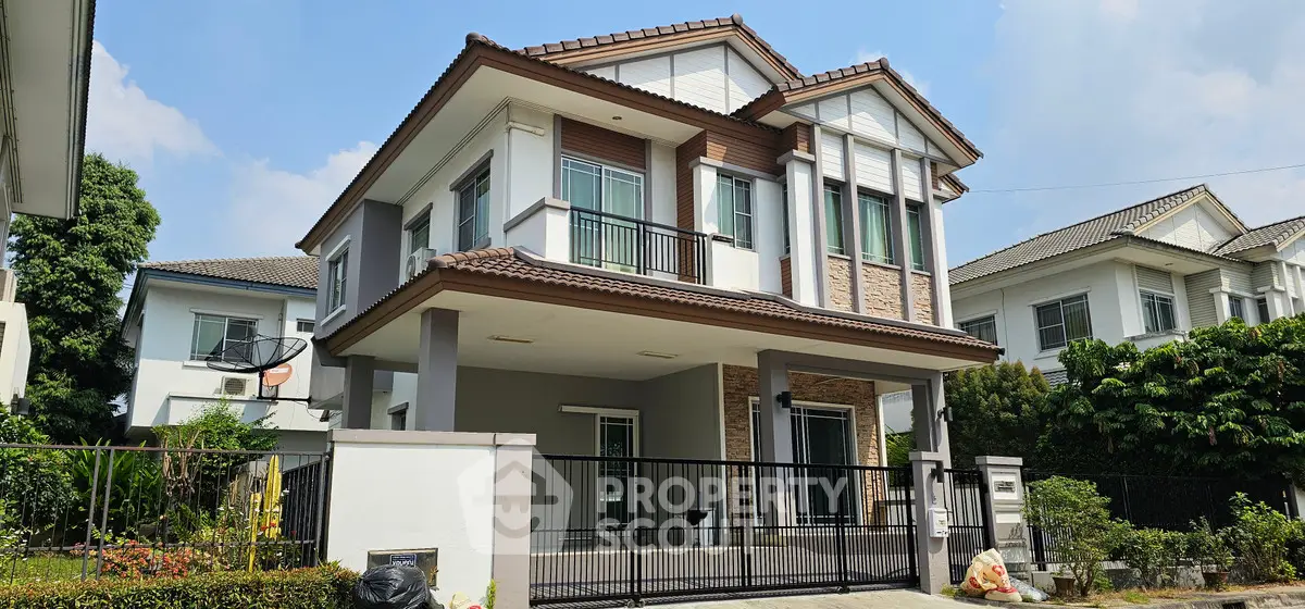 Stunning two-story modern house with elegant facade and lush garden in a serene neighborhood.