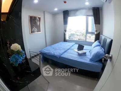Modern bedroom with city view, featuring a cozy bed and stylish decor, perfect for urban living.