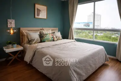 Cozy bedroom with large window and stylish decor in modern apartment