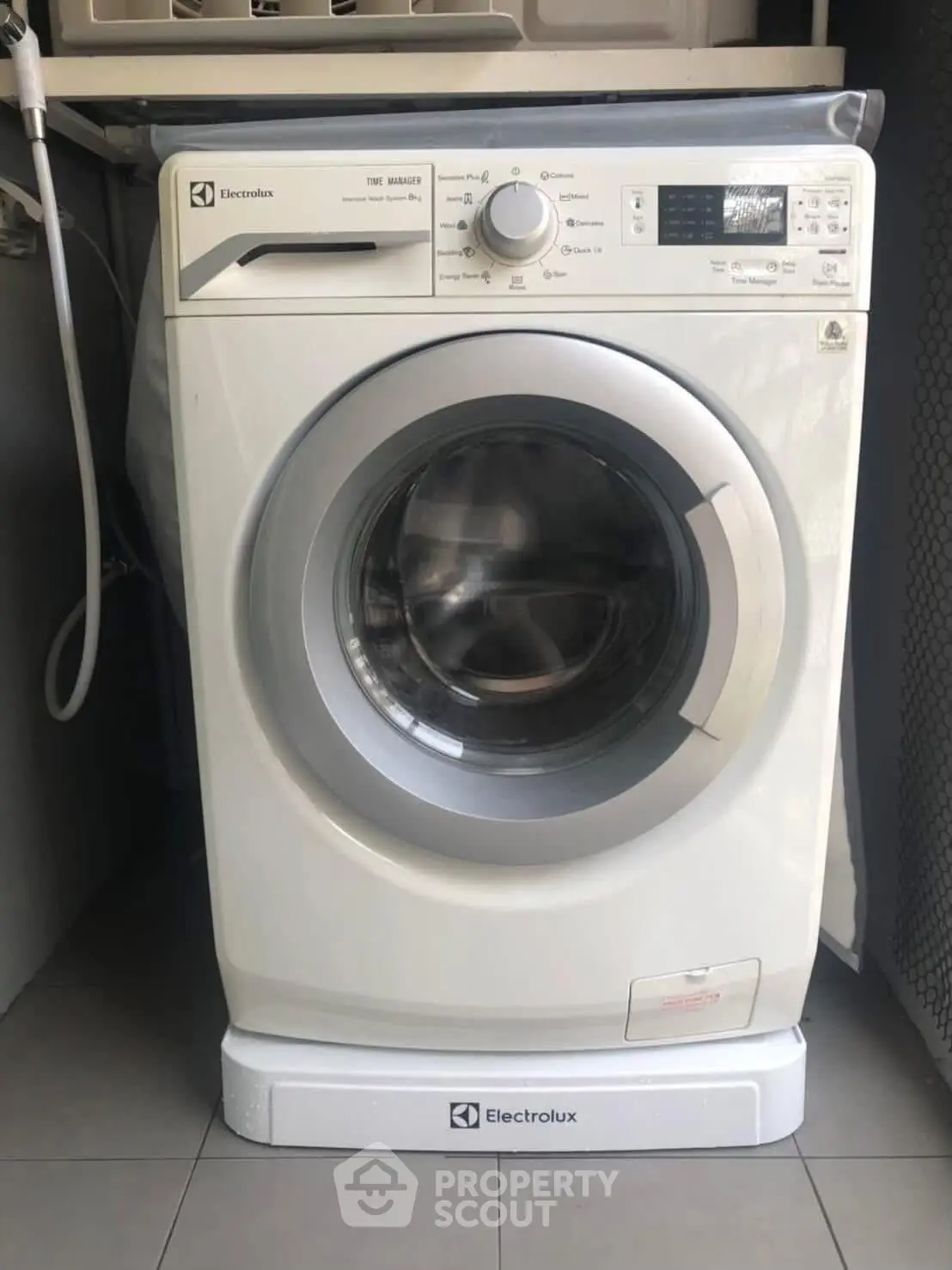 Modern Electrolux washing machine in a sleek laundry area, perfect for efficient home living.