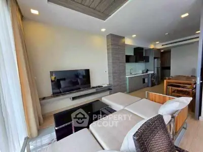 Modern living room with open kitchen layout and stylish decor