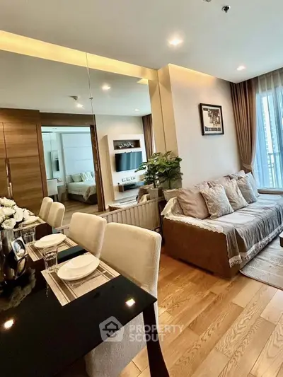 Modern living room with elegant decor and dining area in a stylish apartment.