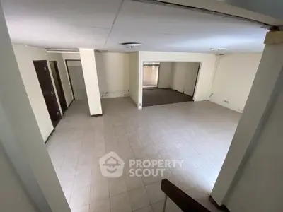 Spacious open-plan living area with tiled flooring and neutral walls, ideal for customization.