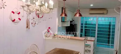 Charming kitchen with nautical decor and modern appliances, featuring a cozy dining area and stylish lighting.