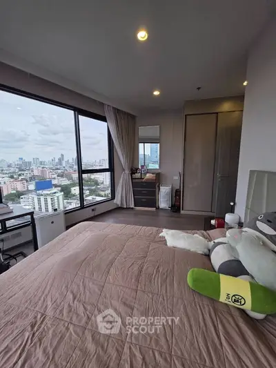 Spacious bedroom with city view in modern high-rise apartment