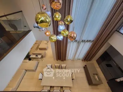 Luxurious modern living room with high ceilings and elegant lighting fixtures