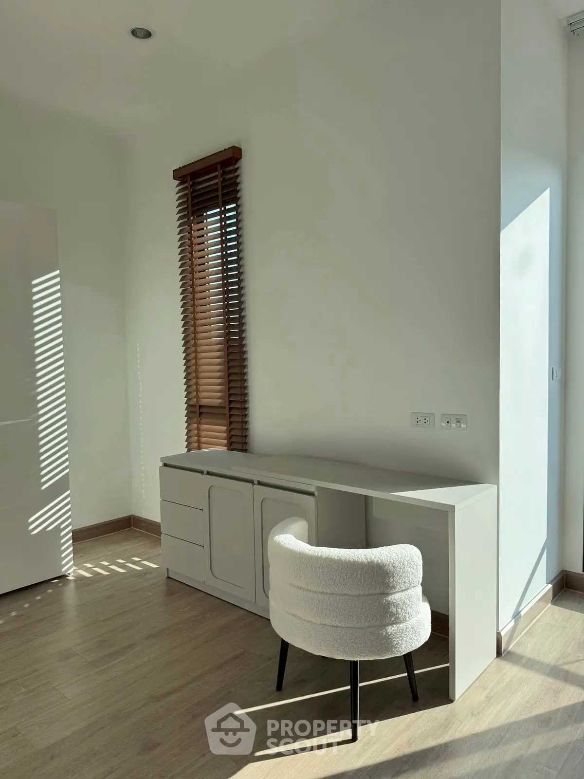 Bright study area with modern desk and cozy chair, perfect for productivity.