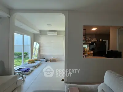 Spacious modern living room with large windows and minimalist decor