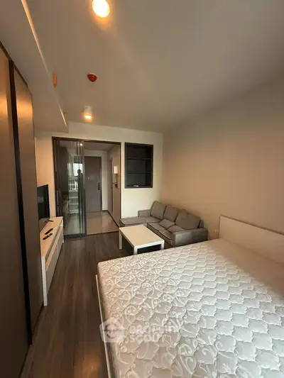 Modern studio apartment with cozy living area and stylish furnishings