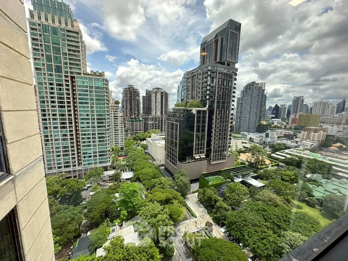 Stunning cityscape view from high-rise building with lush greenery and modern architecture.