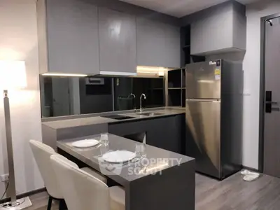 Modern kitchen with sleek gray cabinets and stainless steel appliances