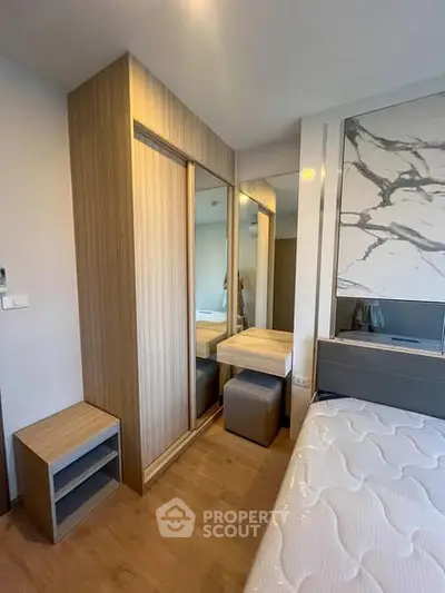 Modern bedroom with stylish wooden wardrobe and comfortable bed