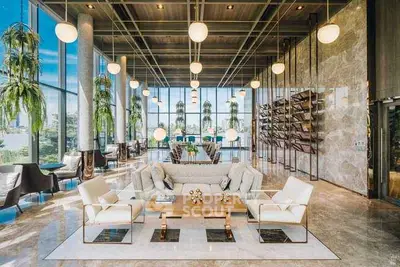 Luxurious modern living room with high ceilings, elegant decor, and panoramic windows offering stunning views.