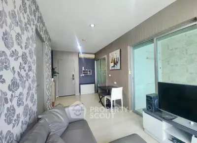 Modern living room with stylish wallpaper and sleek furniture in a contemporary apartment.