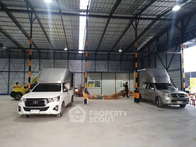 Spacious warehouse interior with vehicles and storage boxes