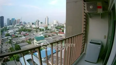 Stunning city view from a high-rise balcony with modern air conditioning unit.