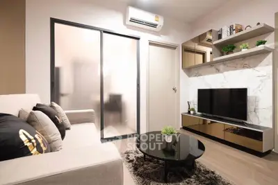 Modern living room with sleek design, featuring a cozy sofa, stylish coffee table, and wall-mounted TV.