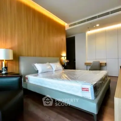 Modern bedroom with stylish lighting and wooden accent wall