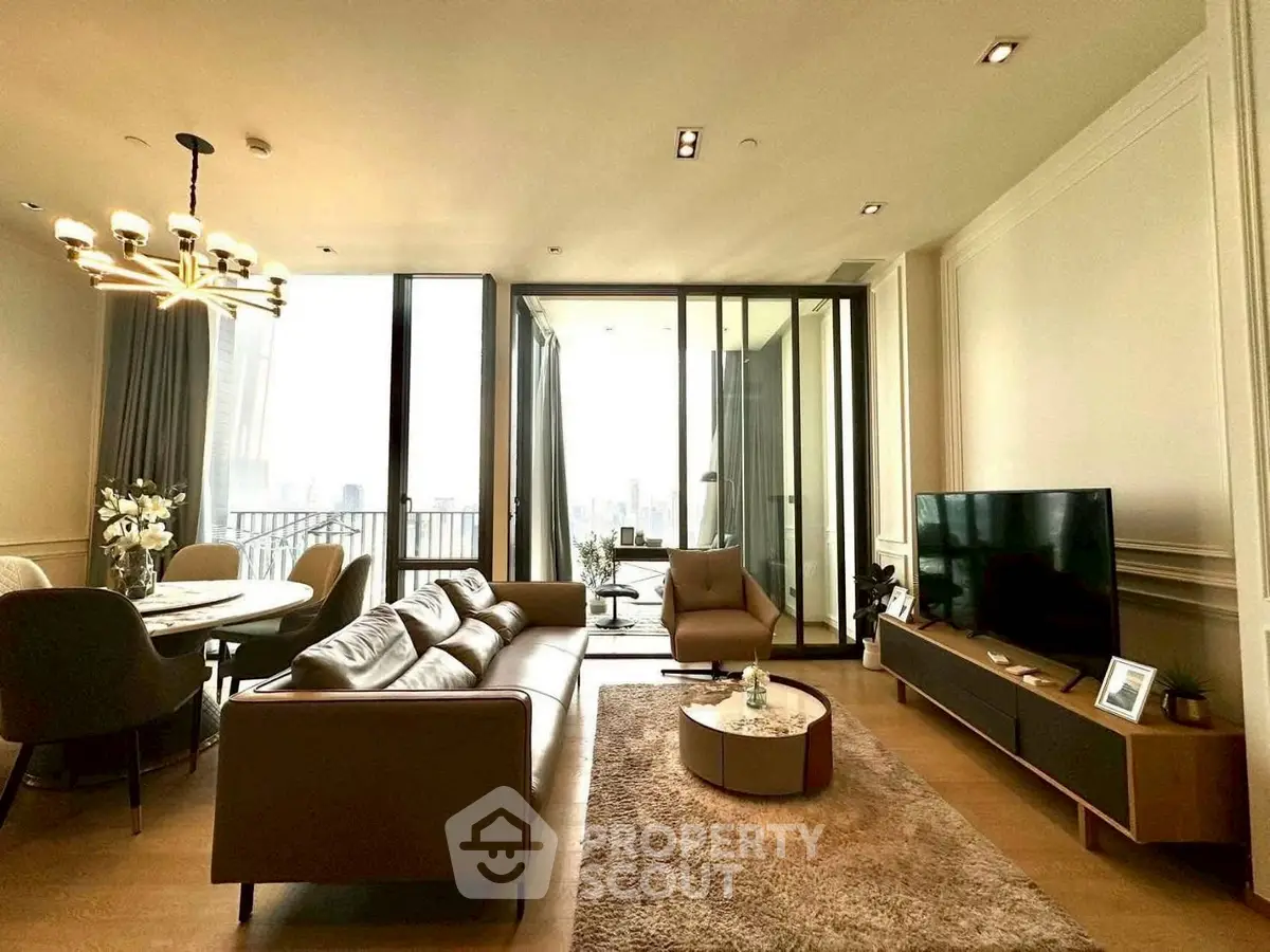 Luxurious living room with modern decor and city view balcony in high-rise apartment.