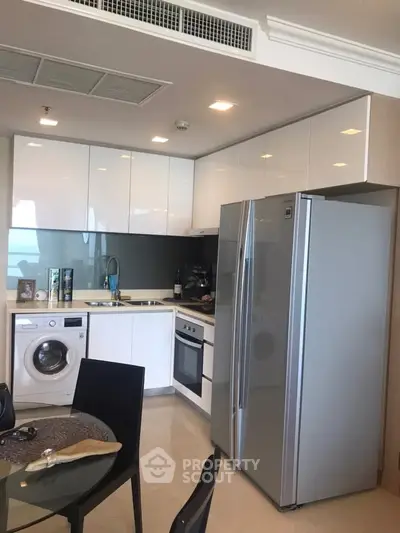 Modern kitchen with sleek appliances and open layout in a stylish apartment.