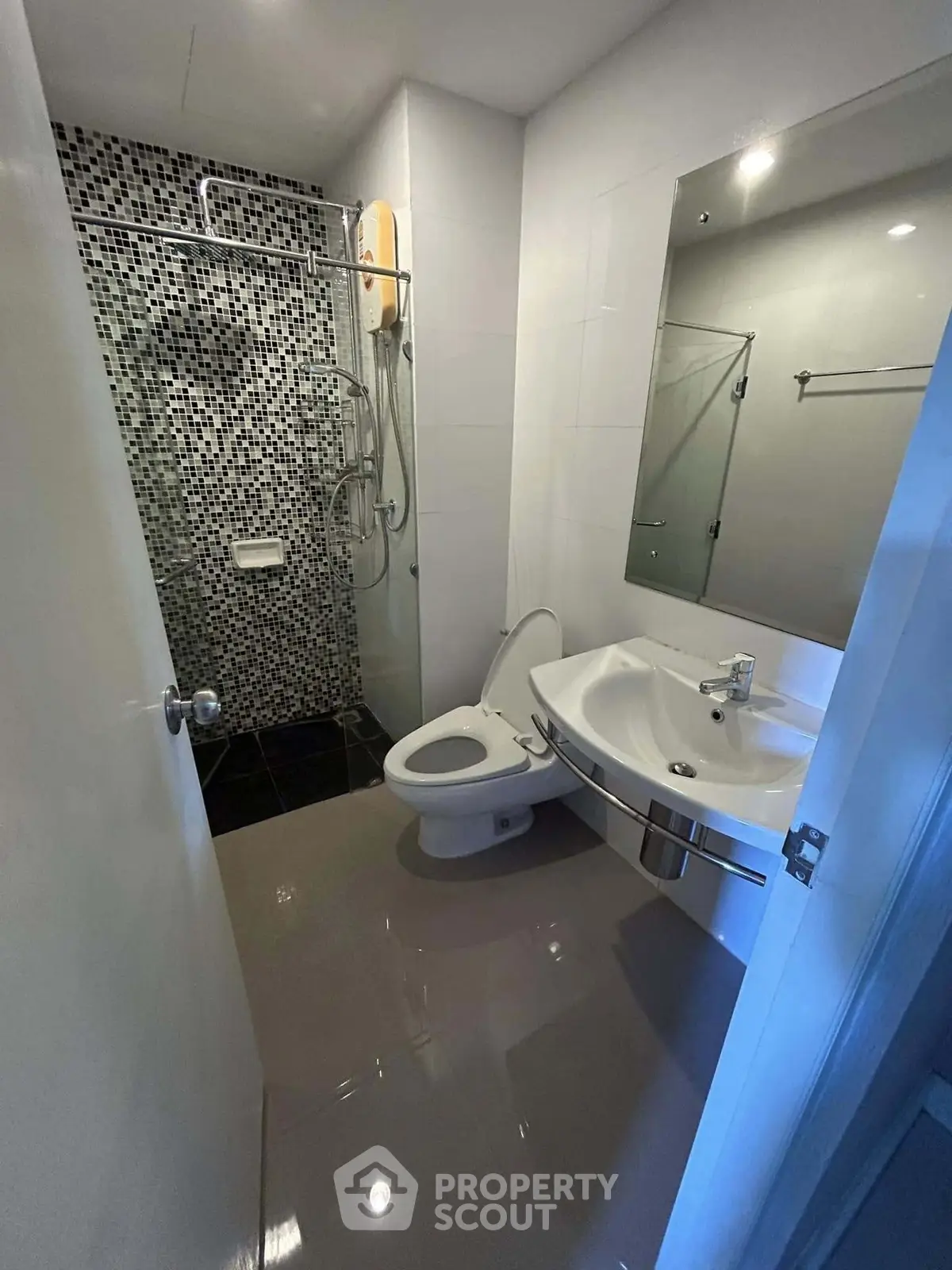 Modern bathroom with sleek fixtures and mosaic tile shower area