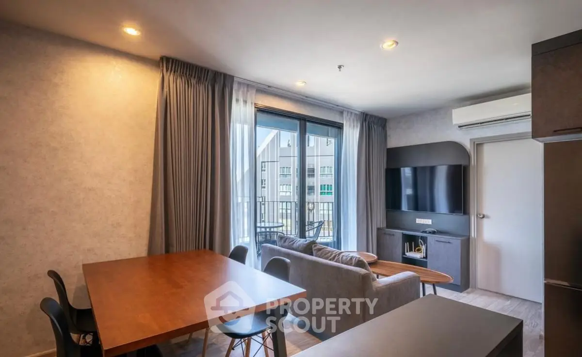 Modern living room with balcony access and stylish furniture