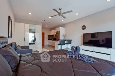 Modern studio apartment with stylish decor, open kitchen, and cozy living area.