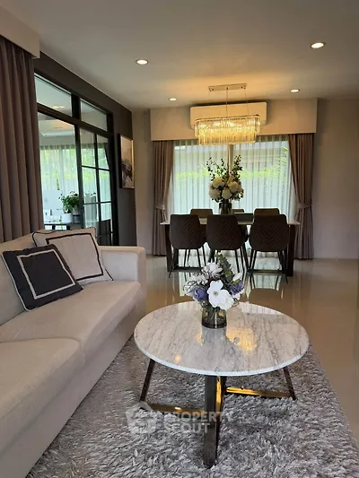 Elegant living room with marble coffee table and chic dining area, perfect for modern living.