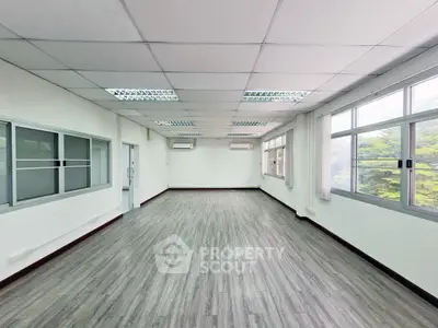 Spacious office space with large windows and modern flooring