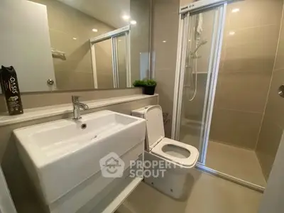 Modern bathroom with sleek fixtures and glass shower enclosure