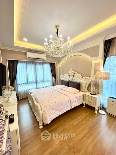 Luxurious bedroom with elegant chandelier and classic furniture design