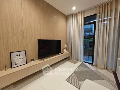 Modern living room with sleek TV setup and floor-to-ceiling curtains