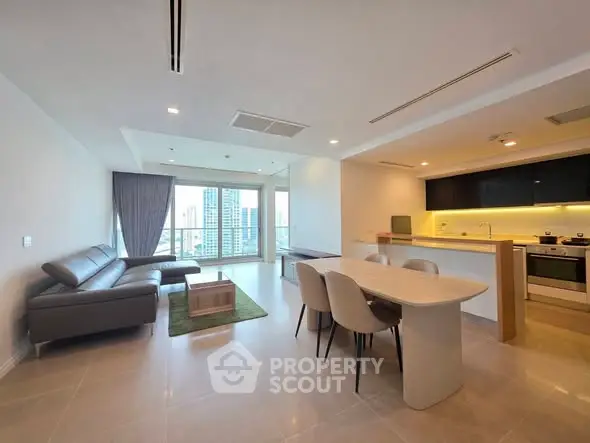 Spacious modern living room with open kitchen and city view