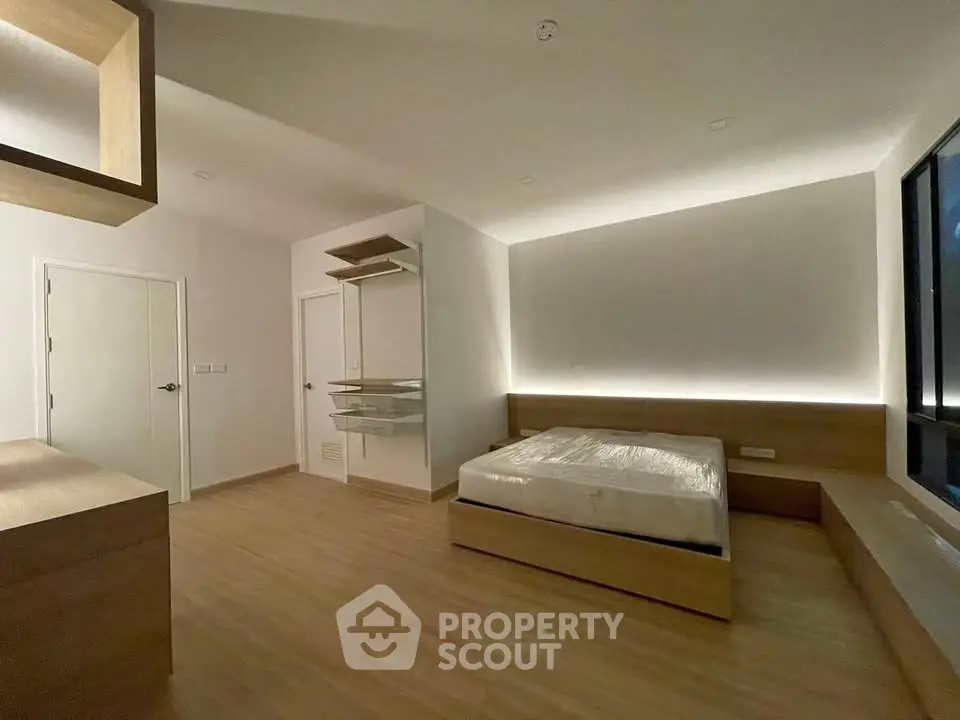 Spacious modern bedroom with minimalist design and ambient lighting