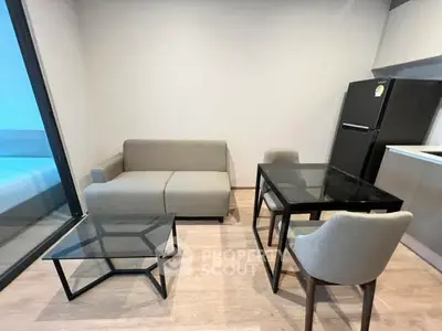 Modern living room with sleek furniture and glass table in a stylish apartment.