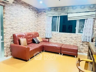 Stylish living room with brick accent wall and leather sectional sofa.