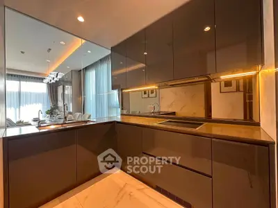Luxurious modern kitchen with sleek cabinetry and open layout in a stylish apartment.