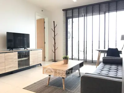 Modern living room with stylish furniture and large windows offering ample natural light.